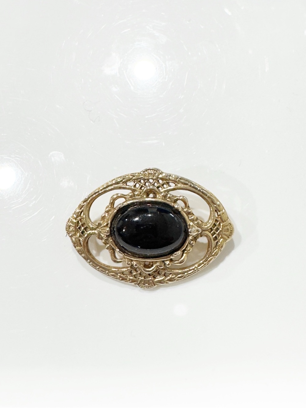 Gold Filigree Brooch with Black Cabochon
